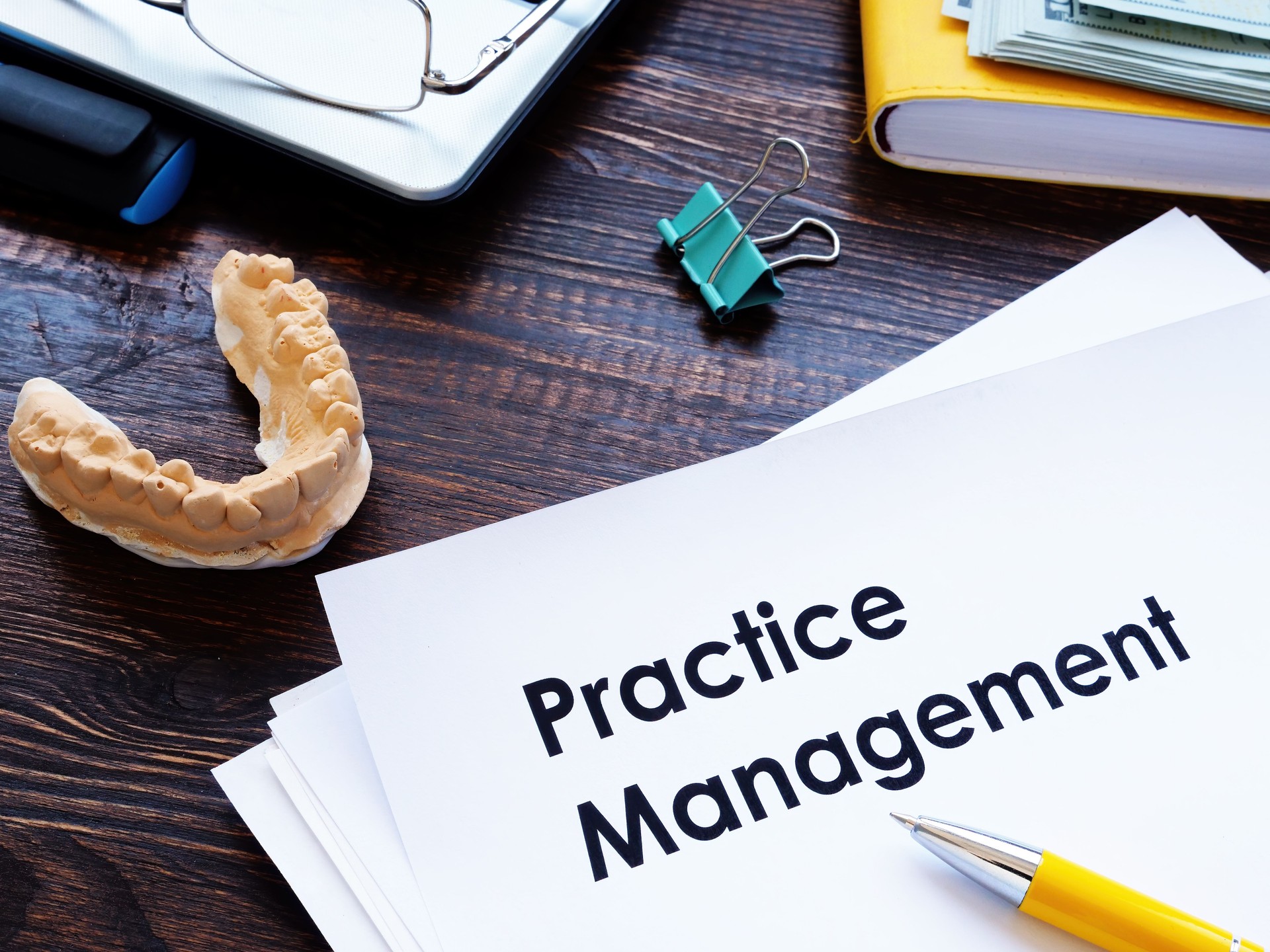 Dental practice management guidelines on desk.